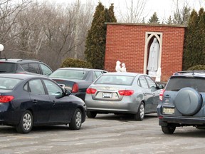 Gathering to pray the rosary, with participants staying in their vehicles, during the COVID-19 pandemic at Our Lady of Good Counsel Church in Sault Ste. Marie, Ont., on Tuesday, April 21, 2020. (BRIAN KELLY/THE SAULT STAR/POSTMEDIA NETWORK)