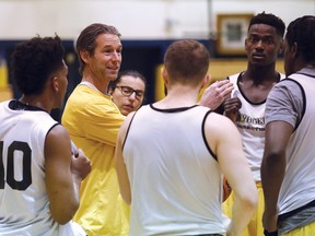 Laurentian Voyageurs men's varsity basketball coach Shawn Swords, second from left, talks to his players during practice at Laurentian University in Sudbury, Ont. on Thursday, January 4, 2018.