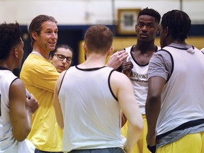 Laurentian Voyageurs men's varsity basketball coach Shawn Swords, second from left, talks to his players during practice at Laurentian University in Sudbury, Ont. on Thursday, January 4, 2018.