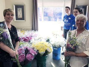 Slaman Greenhouses in Burford donated bouqets of flowers to Chartwell Tranquility Place on Powerline Road, which staff delivered to the 220 residents of the retirement home. In the photo are staff Lisa Marson, Laura Middelkoop, Angelina Marson and Nancy Good. Submitted Photo
