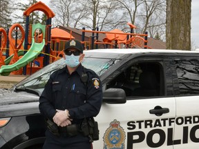 Pictured, Stratford police Const. Darren Fischer poses for a photo with a mask and gloves on in Upper Queens Park. (Beacon Herald file photo)