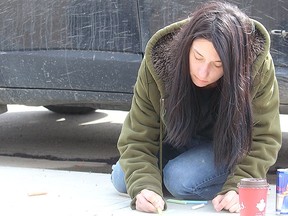 Kelsey Wells colours a street in Spruce Grove earlier in the COVID-19 pandemic. The City recommended activities like this as part of their Connect the Block initiative that just launched in October.