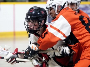 Wallaceburg Red Devils' Aaron Underwood, left, battles Six Nations Rebels' Jesse Longboat in the third period at the Ken Houston Memorial Agricultural Centre in Dresden on June 9, 2019. Mark Malone/Postmedia Network