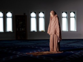 Hassna Moussa prays at the London Muslim Mosque in London.