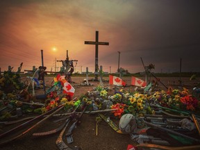 LEAH HENNEL PICTURE OF THE YEAR - This picture, shot in late August, captures an eerie evening near Nipawin, Sask., at the road-side memorial of the Humboldt Broncos' bus crash. With smoke from the B.C. forest fires dimming the sunset, it created a moody atmosphere as Broncos were about to open their 2018 training camp.  Leah Hennel/Postmedia ORG XMIT: POS1812161539190526