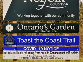 Health advisories regarding the COVID-19 coronavirus have become part of Norfolk County’s branding during this pandemic emergency. Signs at the gateways to Ontario’s Garden carry news of public health orders. – Monte Sonnenberg photo