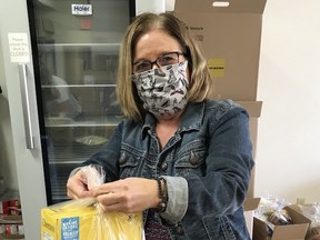 Rotary Club of Kenora president Kelly Williams ties one of 343 bags packaged for this week’s Nutrition on Weekends (NOW) Kenora program.