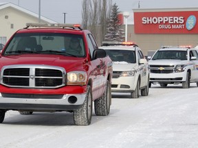 A convoy of police and fire services vehicles drive past the hospital in Stony Plain Tuesday, March 31, 2020 to thank workers for how they have been serving the public during the COVID-19 outbreak. The fire department in Stony is now actively seeking new recruits.