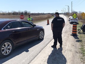 First Nations staff screen cars going across the bridge onto Walpole Island on April 2. Walpole Island restricted almost all non-resident travel to the community on April 1 in an effort to slow the spread of COVID-19. Jake Romphf/Courier Press