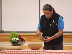 Elder Wilson Bearhead performs the naming ceremony for the Mills Haven Elementary Spirit Bear. Travis Dosser/News Staff/File