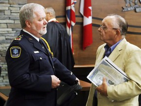 Centre Hastings Mayor Tom Deline, right, talks with Acting Chief Paramedic John O'Donnell after a Hastings County council meeting in Belleville, Ont. Thursday, Aug. 27, 2015. The county is increasing ambulance service, something for which Deline has been advocating for at least five years.