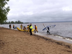 North Bay police and fire service members are seen at Silver Beach Park, Friday afternoon, after receiving an initial report of multiple people in the water at Lake Nipissing. The incident only involved a single windsurfer who was reportedly not in any danger. Michael Lee/The Nugget
