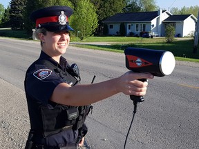 Saugeen Shores Police Service office Laurel Hopkins used a radar gun to check the speeds of passing motorists. Sixty-four speeding charges in a traffic enforcement campaign 'Know the Limit, May 29 -June 12 in Saugeen Shores.