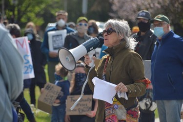 Monique Beaudoin, one of the organizers of Sunday’s demonstration, addresses the crowd, which numbered more than 200.