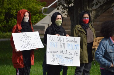 Demonstrators call for racial justice during a declaration of solidarity outside the courthouse on Elm Street on Sunday.