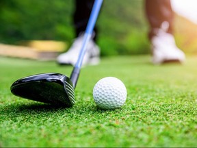 Close up golf ball on green grass