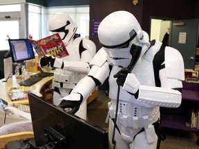 The library building may be closed, but patrons can still chat with a librarian. Stormtroopers from the 501st Badlands Garrison manning the desk at the Airdrie Public Library. 
Photo by APL