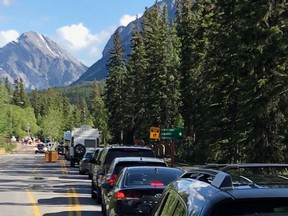 Summer brings higher levels of visitor traffic in the Bow Valley. (Pictured) Lines of slow moving traffic entering Banff last June, 2019. Photo Marie Conboy.