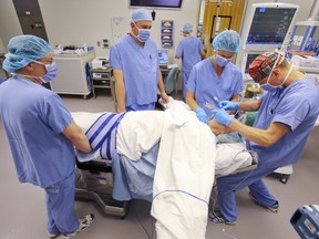 A Quinte Health Care surgical team tends to a patient after an operation in 2014 at Belleville General Hospital.