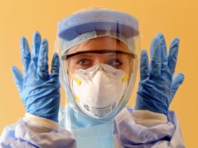 A nurse wears personal protective equipment.