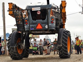 Guests at the 2018 International Plowing Match and Rural Expo watched as a large piece of farming equipment passes by in the opening day parade Sept. 18, 2018. Ontario Plowman's Association officials have announced that this year's Match, to be held in the Lindsay area, has been postponed to 2021. Tom Morrison/Chatham This Week