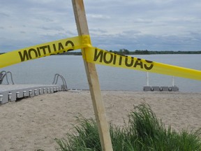 Despite being open, the Morrisburg beach is still home to yellow caution tape. Photo taken on Thursday May 28, 2020 in Cornwall, Ont. Francis Racine/Cornwall Standard-Freeholder/Postmedia Network