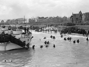Library and Archives Canada
Landing craft 299 lands at Juno Beach, Courseilles-sur-Mer, France, on June 6, 1944. The men making their way ashore were members of the Stormont, Dundas, and Glengarry Highlanders.

Handout Not For Resale