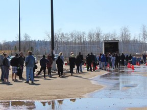 People affected by April's flooding in Fort McMurray wait for hampers from the Wood Buffalo Food Bank at MacDonald Island Park on Saturday, May 2, 2020 for a box of donated food. Laura Beamish/Fort McMurray Today/Postmedia Network