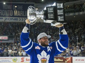 Toronto Marlies' Richard Clune hoists up the Calder Cup after defeating the Texas Stars in Game 7 of the AHL championship at the Ricoh Coliseum in Toronto, Ont., on Thursday, June 14, 2018. Ernest Doroszuk/Toronto Sun/Postmedia