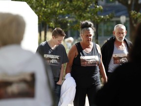 Issaiah Clachar's mother, Caroline Letourneau, middle, is flanked by family friend Summer Willett and Clachar's stepfather Larry Paxman before entering the Ottawa courthouse on Oct. 7, 2015.