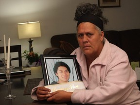 Issaiah Clachar's mother Caroline Letourneau, seen holding his picture in this file photo from Friday, Oct. 2, 2015, in Ottawa, Ont.