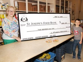 Linda McLaren, treasurer of the St. Joseph's Food Bank, recently accepted a donation for $210 from Jett Denault, 6, which is the proceeds from the sale of rainbow cookies he made with his mom Ashley in the hopes of making people smile.