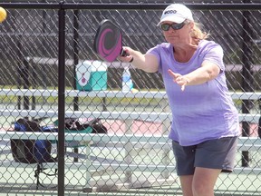 Sheri Shafer prepares to hit a ball during a game of pickleball on the courts in Spruce Grove Friday. The spaces recently reopened after months of lockdown due to COVID-19. 

Evan J. Pretzer