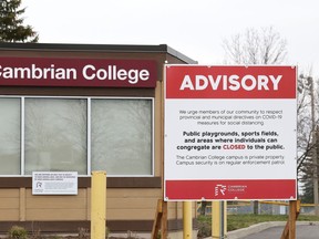 Signs are posted at Cambrian College in Sudbury, Ont. advising the public to follow provincial and municipal COVID-19 directives on campus property.