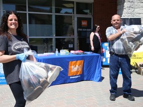 Kyla Rouleau, of BioPed Footcare in Sudbury, Ont., and Bob Johnston, of Tomorrow's Hope, display a selection of gently-worn shoes that were donated to the drop-off site at BioPed in Sudbury, Ont. on Thursday May 21, 2020. BioPed will be providing new properly fitting shoes to TomorrowÕs Hope, which will distribute the shoes to homeless in the near future. BioPed is also providing new socks for the homeless. Donated shoes from the event on Thursday will go to the Soles4Souls program.