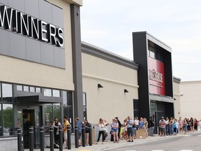Shoppers line up as they wait their turn to enter Winners and HomeSense at the Silver Hills shopping complex on May 28.