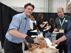 Jacob Ford, of Boar’s Head, serves his version of pork hocks to attendees at the 2019 Ontario Pork Congress