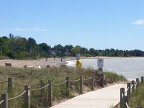 A few walkers on a windy Southampton beach Sunday, May 31, 2020. Saugeen Shores reopened its beaches Friday but the medical officer of health said Sunday that's not what he intended when he rescinded his beach-closure order Thursday. (Photo by Frances Learment/Shoreline Beacon Times/Postmedia Network)