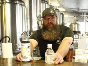Jonathan St-Pierre, founder and co-owner of the Full Beard Brewing Company, displays a can of the new beer they've produced named "Together, We Are Stronger." They will be donating $4,500 from the sales of the beer and some hand sanitizers towards the Timmins Chamber's Personal Protective Equipment (PPE) support grant.

RICHA BHOSALE/The Daily Press
