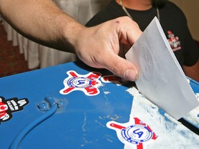 A member of United Association of plumbers and pipefitters casts a ballot in Calgary in this July 2007 file photo.