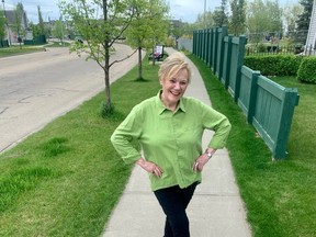 Resident Carm Paravicini stands over a sidewalk chalk message as part of a campaign for Seniors' Week in Strathcona County. Photo Supplied