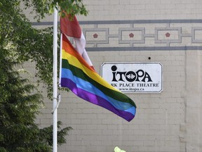 Pride Month officially kicked off Monday with the raising of the Pride flags in three locations across Oxford County. Pictured the Pride is raised at the flagpole on Thames Street with a few onlookers and organizers from Oxford County Pride to mark the occasion.  Flags were also raised earlier in the day in Tillsonburg and Woodstock. This year many Pride month activities organized by Oxford County Pride will be held online because of the COVID-19 pandemic – see Oxford County Pride on Facebook for details. (Kathleen Saylors/  Woodstock Sentinel-Review)