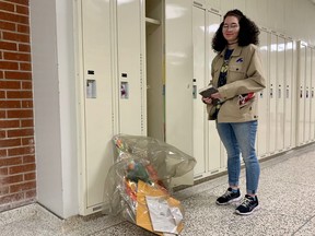 Elizabeth Clark marked the end of her victory lap at Delhi District Secondary School on Tuesday by cleaning out her locker. Students have been unable to access the items left in their lockers before March Break until this week. (ASHLEY TAYLOR)