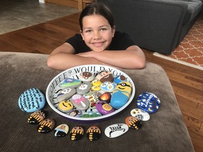 Orlagh Grochmal, 11, is shown with some of the rocks she has painted. Recently, she has been leaving in a few public areas in Chatham and on the doorsteps of people she knows. (Handout/Postmedia Network)