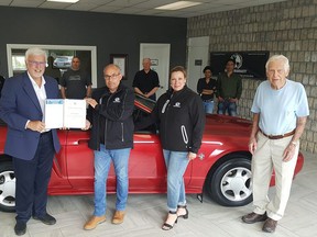 Chatham-Kent-Leamington MPP Rick Nicholls presents a congratulatory letter and certificate to Mike Feasey, president of Banks Auto. Also shown at front are Feasey's wife and co-owner, Heidi, and original dealership owner, Ted Banks. The Charing Cross dealership was established in 1948 but is closing due to retirement. At back are Don Spence, bookkeeper, Selina Langis, detailer, Rick Dulisch, past-mechanic, Sandy Blackshaw, sales, and Shantha Karu and Thaya Thantha, the building's new owners. Trevor Terfloth/Postmedia Network