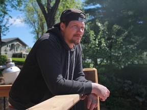 Jesse Winberg peers out at Lake of the Woods at the property he's been doing some yard work at.