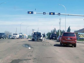 Residents appear to be filling potholes on Highway 16 in Stony Plain on the weekend.