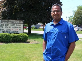 Deve Persad, pastor of Sarnia Evangelical Missionary Church, stands outside the church building where a drop-off food drive will be held Sunday.