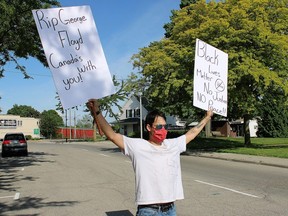 Micheal Whitsone protests near the Chatham-Kent police station in Wallaceburg, Ont., on Thursday, June 4, 2020. He joined those from all over the world protesting police brutality and systemic racism following the death of George Floyd. (Jake Romphf/Postmedia Network)