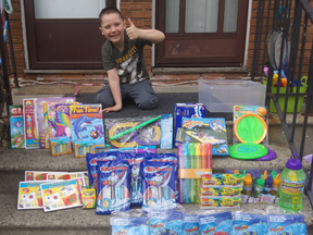 Chase McLean, 7, gives the thumbs up for some of the early donations to a Water Family Fun project in the High Park Public School neighbourhood of Sarnia.